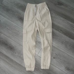 PRETTYLITTLETHING cream/ivory leather jogger pants with front zipper. Very cute